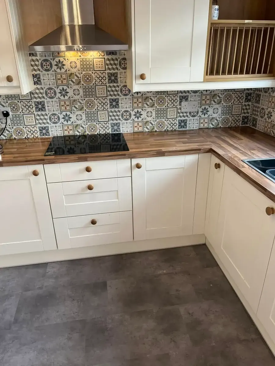 Kitchen installation in South Wales — cream shaker units, walnut worktops and patterned tile splashback
