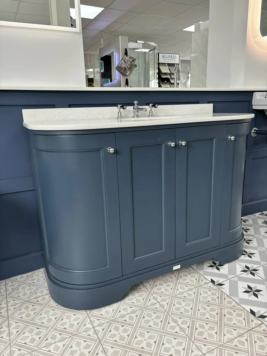 Traditional navy curved four-door vanity unit with marble-effect worktop and chrome crosshead taps