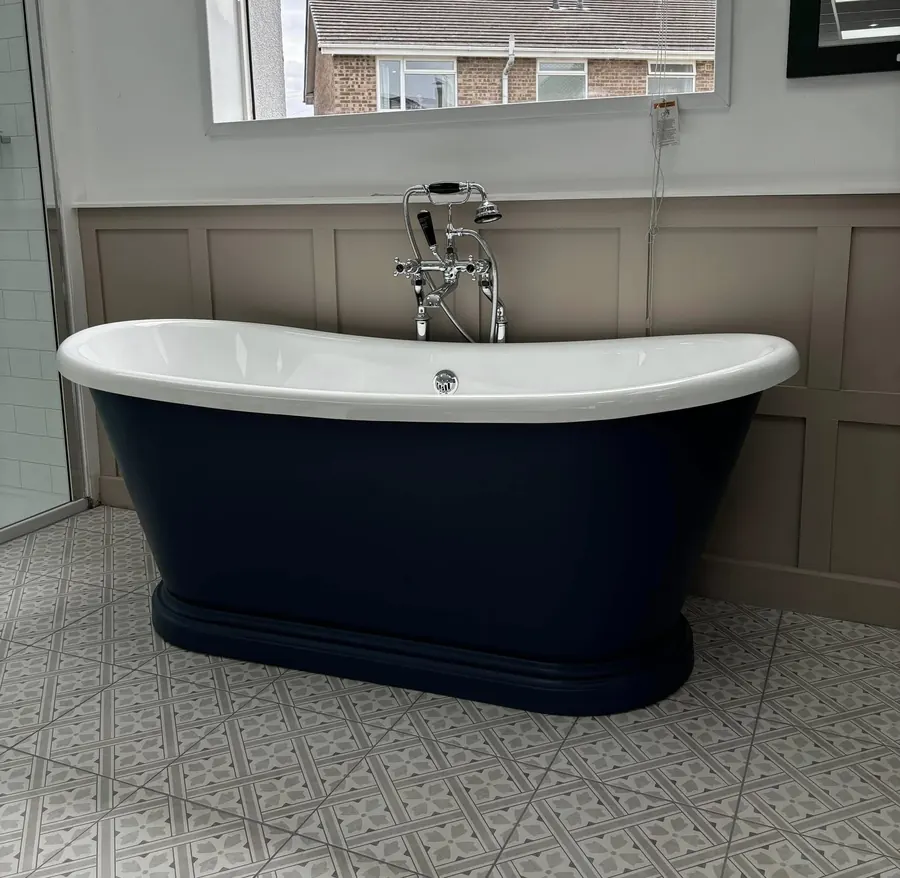 Navy freestanding boat bath with chrome floor-standing bath shower mixer and panelled walls