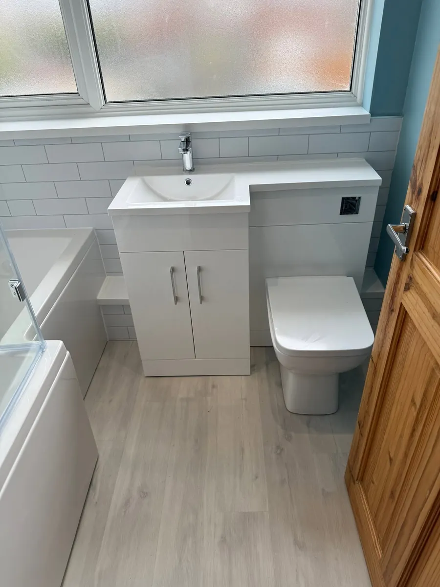 White gloss L-shaped vanity and WC combination unit with metro tiles and chrome mono tap